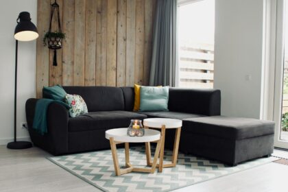 light candle on round white coffee table and sectional sofa