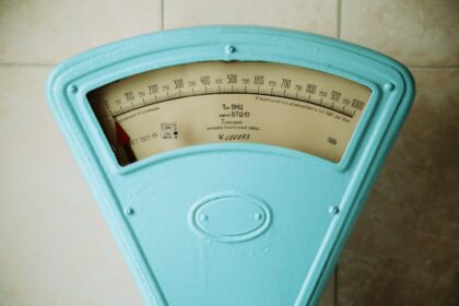 a close up of a meter on a tiled wall