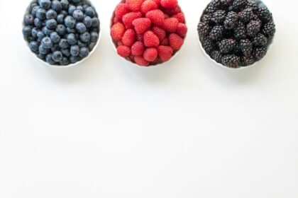 black and red berries on white surface