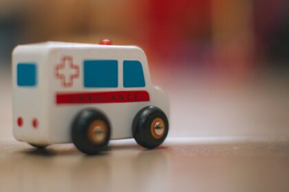 a toy ambulance is sitting on the floor