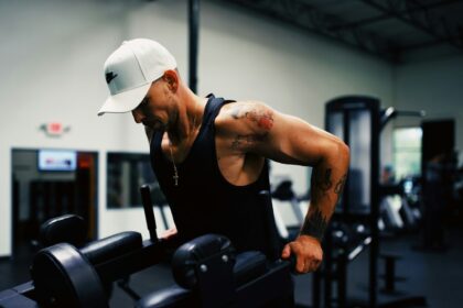 man in black tank top wearing white hard hat