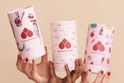 person holding white and pink heart and hearts playing cards