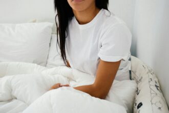 woman sitting on bed