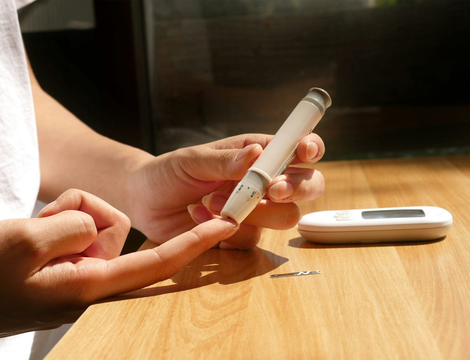 a person sitting at a table with a cell phone