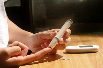 a person sitting at a table with a cell phone